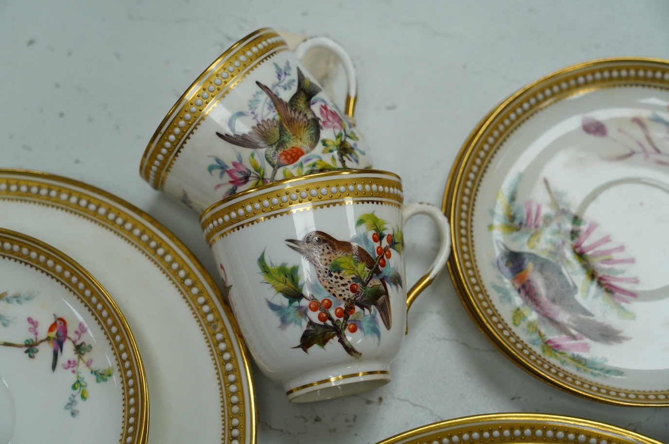 A 19th century Royal Worcester ornithologically decorated part tea set, with gilt and jewelled edges, six place setting. Condition - good